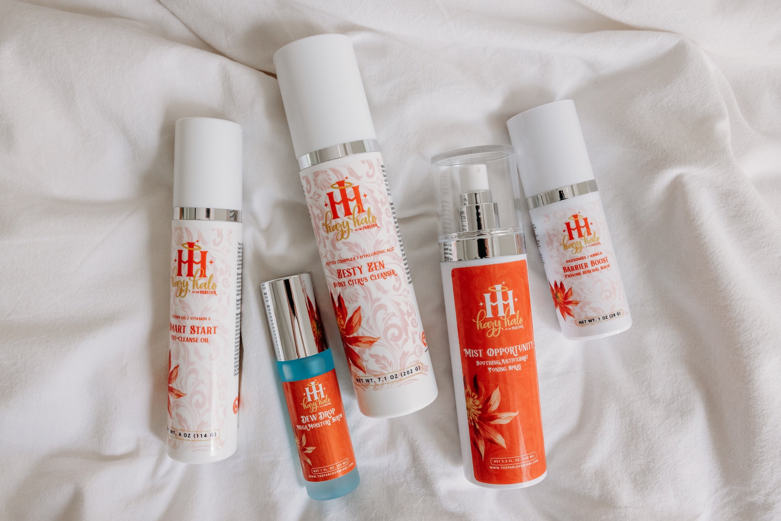Hazy Halo Barrier Repair Collection with Smart Start Pre-Cleanse Oil, Dew Drop Mega Moisture Serum, Zesty Zen Cleanser, Mist Opportunity Toning Spray, and Barrier Boost Exosome Renewal Serum.